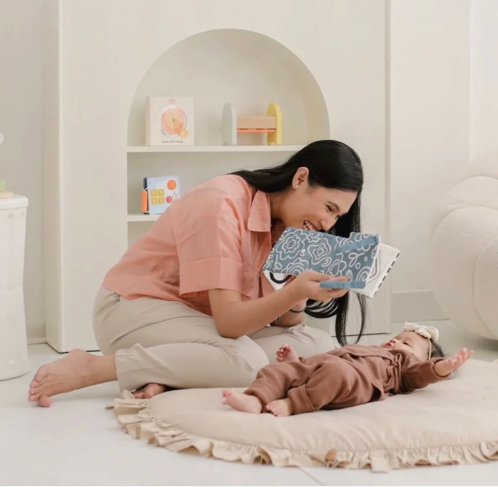 A parent and baby sharing floor play